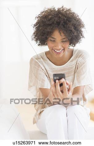 Woman using cell phone View Large Photo Image Stock Image - Woman using cell phone. Fotosearch