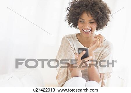 Woman using cell phone, studio shot View Large Photo Image Stock Image - Woman using cell phone, studio shot. Fotosearch