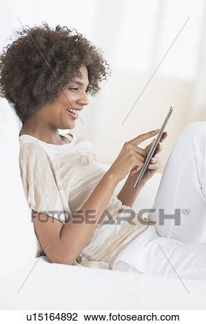 Woman using digital tablet View Large Photo Image Stock Image - Woman using digital tablet. Fotosearch