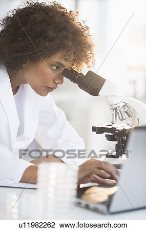 Woman using microscope in laboratory View Large Photo Image Stock Image - Woman using microscope in laboratory. Fotosearch