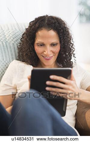 Stock Image - Woman with digital tablet. Fotosearch