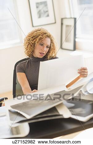 Stock Image - Woman working in art gallery. Fotosearch