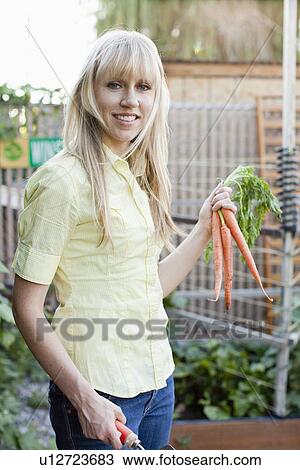 Woman working in garden View Large Photo Image Stock Image - Woman working in garden. Fotosearch
