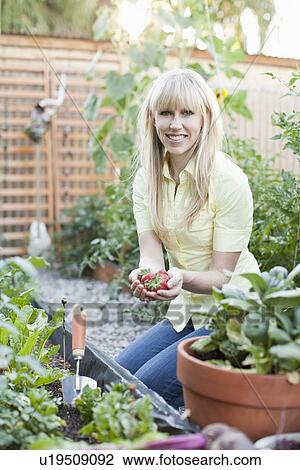 Woman working in garden View Large Photo Image Stock Image - Woman working in garden. Fotosearch