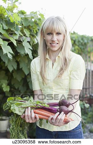 Stock Photo - Woman working in garden. Fotosearch