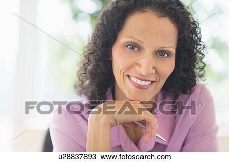Woman working in office View Large Photo Image Stock Image - Woman working in office. Fotosearch