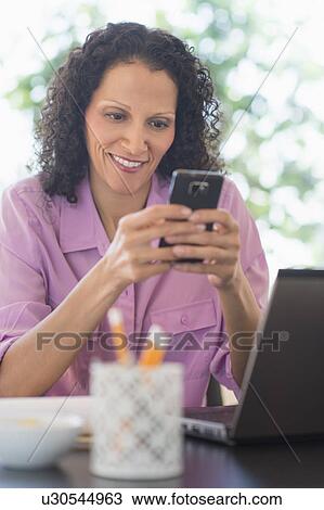 Woman working in office View Large Photo Image Stock Image - Woman working in office. Fotosearch