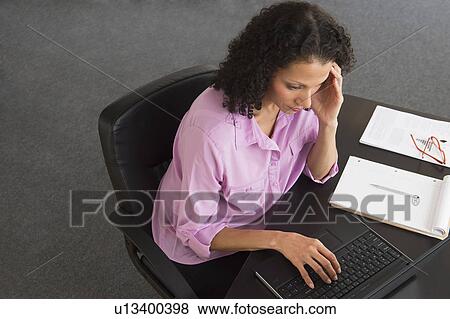 Woman working in office View Large Photo Image Stock Photo - Woman working in office. Fotosearch