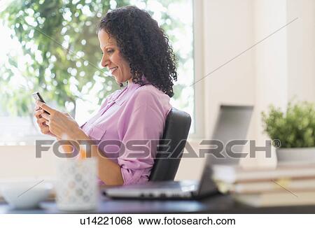 Woman working in office View Large Photo Image Stock Photo - Woman working in office. Fotosearch