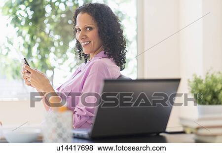 Stock Photo - Woman working in office. Fotosearch