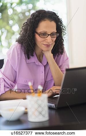 Woman working in office View Large Photo Image Stock Photo - Woman working in office. Fotosearch