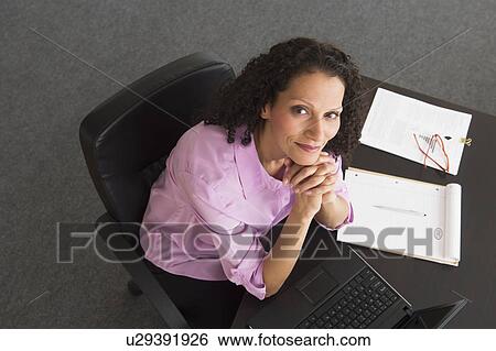 Woman working in office View Large Photo Image Stock Photograph - Woman working in office. Fotosearch