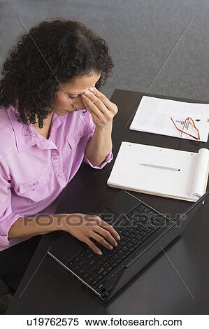 Woman working in office View Large Photo Image Stock Photography - Woman working in office. Fotosearch