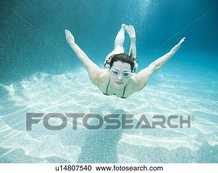 Young attractive woman diving in swimming pool View Large Photo Image Stock Image - Young attractive woman diving in swimming pool. Fotosearch