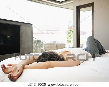 Young attractive woman lazing in bed View Large Photo Image Stock Photography - Young attractive woman lazing in bed. Fotosearch