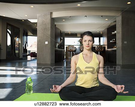 Stock Image - Young attractive woman practicing yoga. Fotosearch