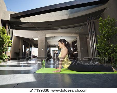Stock Photograph - Young attractive woman practicing yoga. Fotosearch