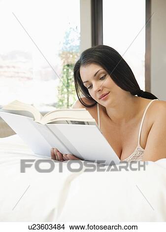 Young attractive woman reading book in bed View Large Photo Image Picture - Young attractive woman reading book in bed. Fotosearch