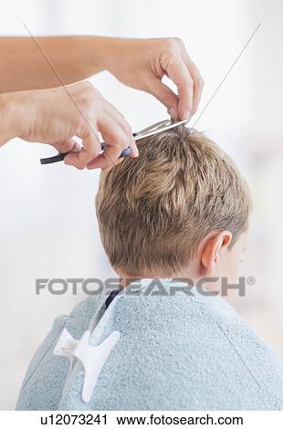 Young boy (6-7) undergoing haircut View Large Photo Image Stock Image - Young boy (6-7) undergoing haircut. Fotosearch