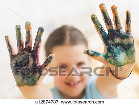 Young girl (8-9) showing hands stained with paint View Large Photo Image Stock Photo - Young girl (8-9) showing hands stained with paint. Fotosearch