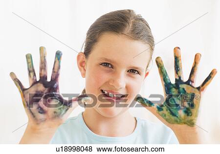 Young girl (8-9) showing hands stained with paint View Large Photo Image Stock Photo - Young girl (8-9) showing hands stained with paint. Fotosearch