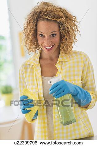 Young woman cleaning in kitchen View Large Photo Image Stock Photograph - Young woman cleaning in kitchen. Fotosearch