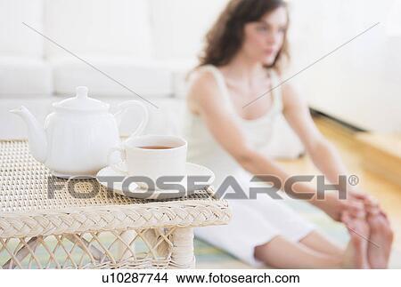 Picture - Young woman exercising at home. Fotosearch