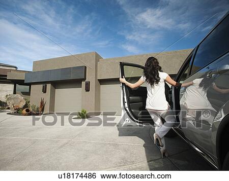 Young woman getting in car View Large Photo Image Stock Photograph - Young woman getting in car. Fotosearch