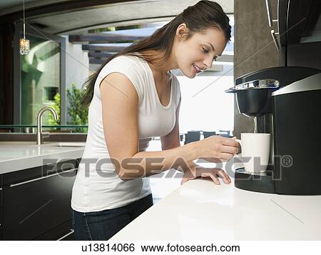Young woman making morning coffee View Large Photo Image Stock Photograph - Young woman making morning coffee. Fotosearch