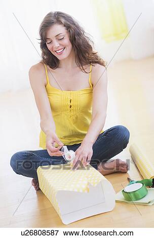 Young woman packing presents View Large Photo Image Stock Photo - Young woman packing presents. Fotosearch