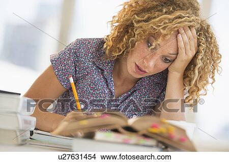 Young woman studying in library View Large Photo Image Picture - Young woman studying in library. Fotosearch