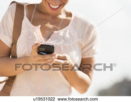 Young woman using mobile phone View Large Photo Image Stock Image - Young woman using mobile phone. Fotosearch