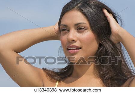 Young woman with hands in hair View Large Photo Image Stock Photo - Young woman with hands in hair. Fotosearch