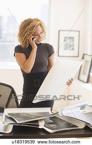 Young woman working in art gallery View Large Photo Image Stock Photo - Young woman working in art gallery. Fotosearch
