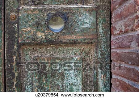 Ancient wooden panelled door with peeling and blistered paint, surrounding red brick wall, medieval village, Umbria, Italy View Large Photo Image Picture - Ancient wooden panelled door with peeling and blistered paint, surrounding red brick wall, medieval village, Umbria, Italy. Fotosearch