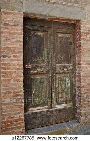 Ancient wooden panelled door with peeling and blistered paint, surrounding red brick wall, medieval village, Umbria, Italy View Large Photo Image Stock Photography - Ancient wooden panelled door with peeling and blistered paint, surrounding red brick wall, medieval village, Umbria, Italy. Fotosearch