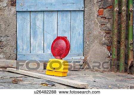 Blue wooden plank door with crumbling stone wall, green pipes, and workman's red and yellow sign with planks in front on stone pathway, Monterosso al Mare, Cinque Terre. Liguria, Italy View Large Photo Image Stock Photo - Blue wooden plank door with crumbling stone wall, green pipes, and workman's red and yellow sign with planks in front on stone pathway, Monterosso al Mare, Cinque Terre. Liguria, Italy. Fotosearch