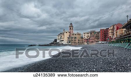 Camogli: beach and sea with waves motion blur, church tower and surrounding buildings beyond, grey sky with dramatic clouds, Liguria, Italy View Large Photo Image Stock Photo - Camogli: beach and sea with waves motion blur, church tower and surrounding buildings beyond, grey sky with dramatic clouds, Liguria, Italy. Fotosearch