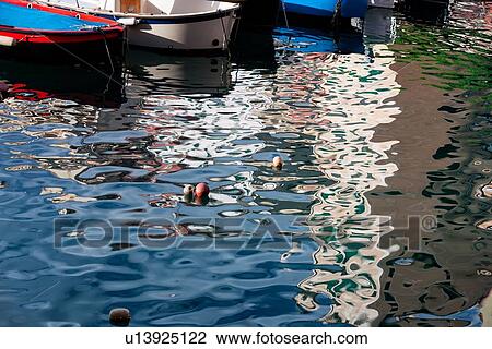 Camogli: fishing boats reflected in water late afternoon sunlight, detail, Liguria, Italy View Large Photo Image Stock Image - Camogli: fishing boats reflected in water late afternoon sunlight, detail, Liguria, Italy. Fotosearch