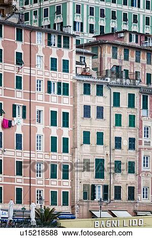 Camogli: sea front apartment buildings painted pink, cream, green with lines of green wooden shutters, and laundry hanging, detail of rectangular patterns, Liguria, Italy View Large Photo Image Stock Photo - Camogli: sea front apartment buildings painted pink, cream, green with lines of green wooden shutters, and laundry hanging, detail of rectangular patterns, Liguria, Italy. Fotosearch
