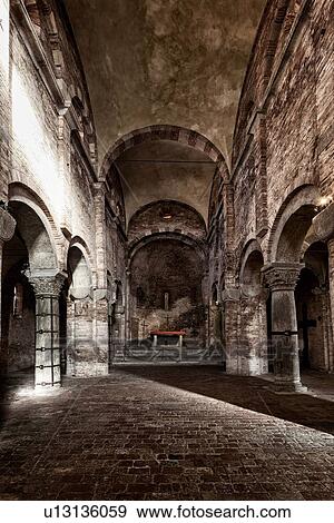 Stock Photo - Church complex of Santo Stefano: Romanesque church of San Vitale e Agricola with plain brick walls and arched central nave, desaturated image, Bologna, Italy. Fotosearch