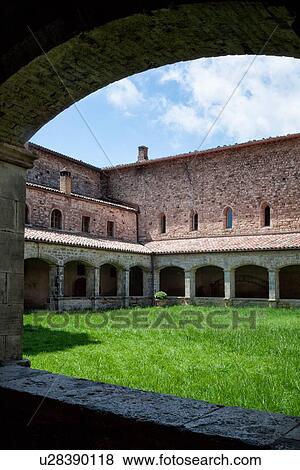 Cloister of San Fortunato, Todi with view of arched stone portico with red tiled roof, and red brick cells above, blue sky in springtime, Umbria, Italy View Large Photo Image Stock Photo - Cloister of San Fortunato, Todi with view of arched stone portico with red tiled roof, and red brick cells above, blue sky in springtime, Umbria, Italy. Fotosearch