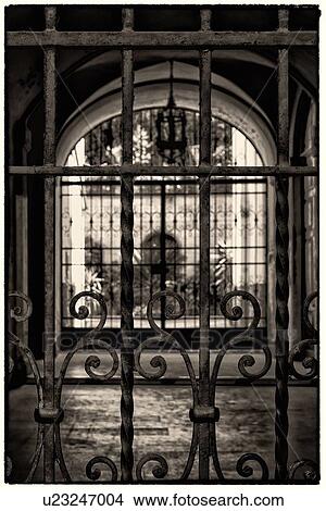 Close up of wrought iron gate with courtyard of flowers and plants in terrracotta vases beyond, monochrome image with shallow depth of field, Orvieto, Umbria, Italy View Large Photo Image Picture - Close up of wrought iron gate with courtyard of flowers and plants in terrracotta vases beyond, monochrome image with shallow depth of field, Orvieto, Umbria, Italy. Fotosearch