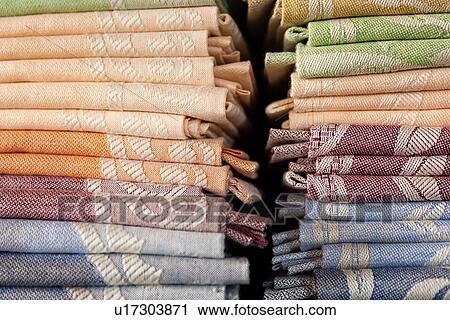 Close up view of display of linen and cotton tablecloths woven on Jacquard loom, 2 piles on shelf, Umbria, Italy View Large Photo Image Stock Image - Close up view of display of linen and cotton tablecloths woven on Jacquard loom, 2 piles on shelf, Umbria, Italy. Fotosearch
