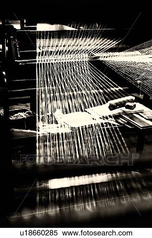 Stock Photography - Close up view of Jacquard loom with pattern formed by linen and cotton threads attached, high key monochrome image, Umbria, Italy. Fotosearch