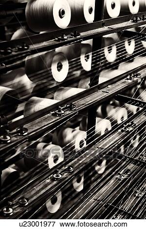 Stock Photo - Close up view of spools of linen and cotton threads on racks with pattern formed by threads, high key monochrome image, Umbria, Italy. Fotosearch