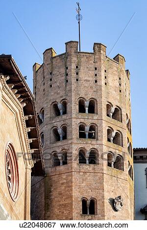 Stock Photo - Close up view of twelve-sided Romanesque -Gothic tower of Sant'Andrea, and plain stone facade of church with rose window Orvieto, Umbria, Italy. Fotosearch
