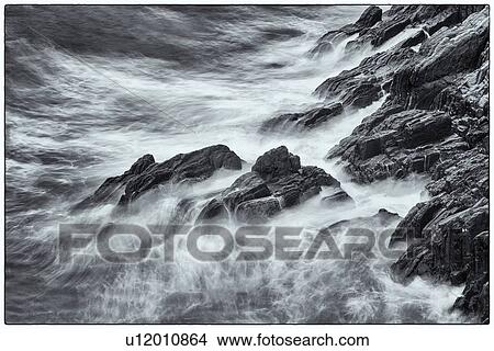 Picture - Detail of heavy seas smashing against rocks, with motion blur, monochrome image, Cinque Terre, Italy. Fotosearch