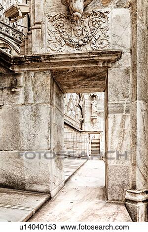 Detail of Milan Duomo rooftop: series of doorways, elaborate stone carving, with stone stairway in distance, desaturated view, Milan Italy View Large Photo Image Stock Image - Detail of Milan Duomo rooftop: series of doorways, elaborate stone carving, with stone stairway in distance, desaturated view, Milan Italy. Fotosearch