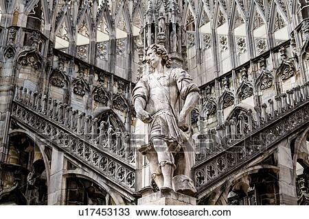 Detail of Milan Duomo rooftop: statue of cavalier soldier with rooftop pinnacles and flying buttresses beyond, elaborate stone carving, Milan Italy View Large Photo Image Stock Image - Detail of Milan Duomo rooftop: statue of cavalier soldier with rooftop pinnacles and flying buttresses beyond, elaborate stone carving, Milan Italy. Fotosearch
